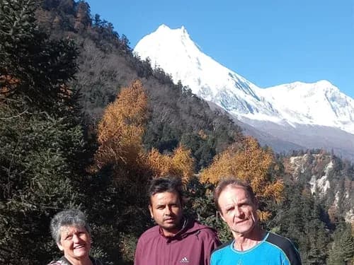 Our trekking guests and porters posing in front of Mount Manaslu, Nepal.